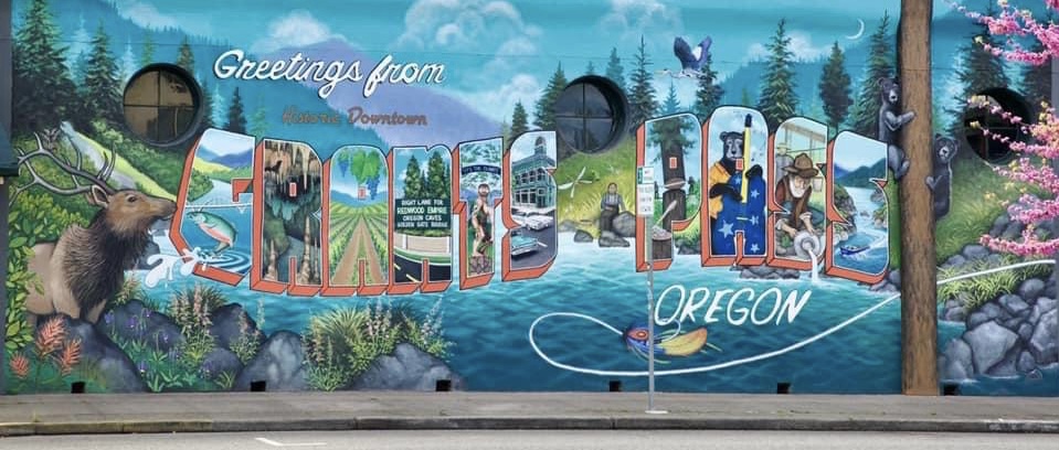 The "Greetings from Historic Downtown Grants Pass, Oregon" mural in downtown Grants Pass