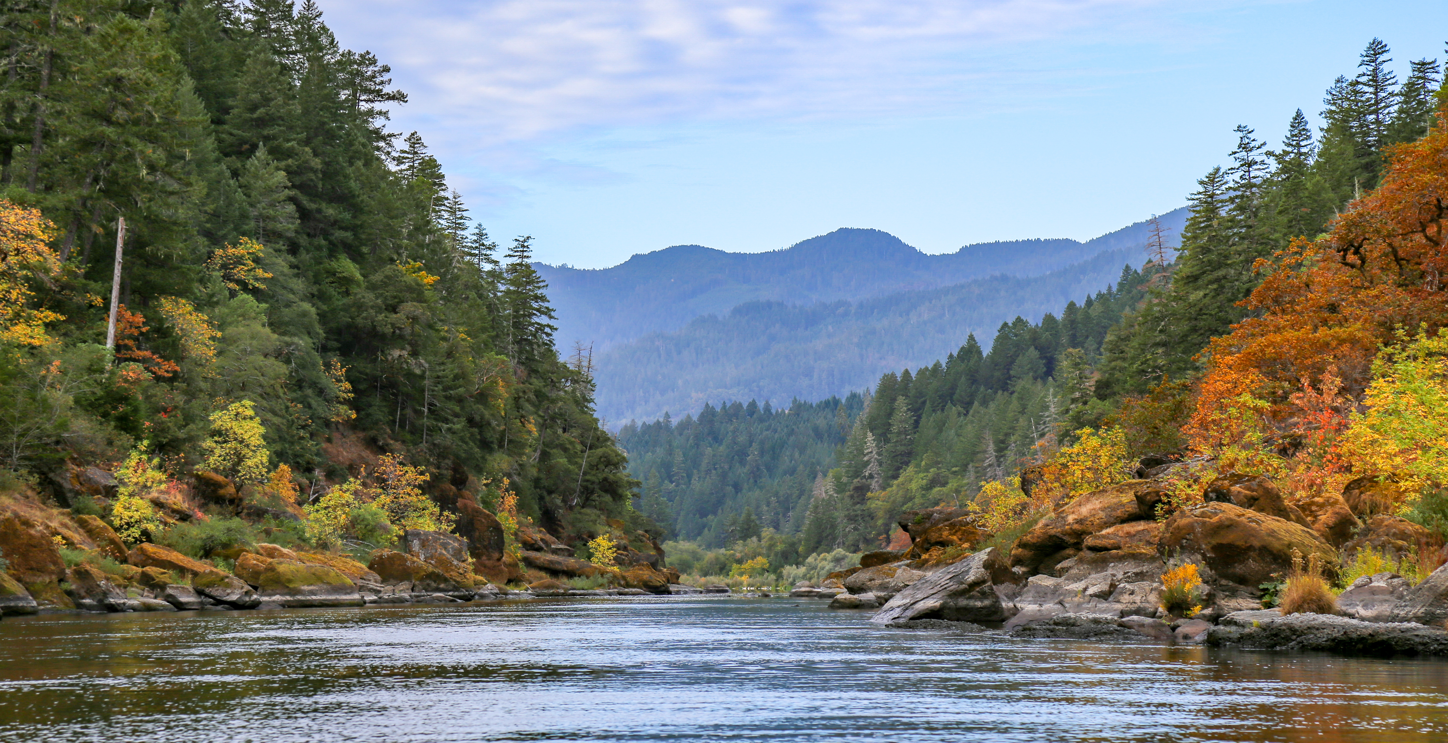 The Wild and Scenic Rogue River downstream of Grants Pass, Oregon, with fir-covered canyon walls and fall color